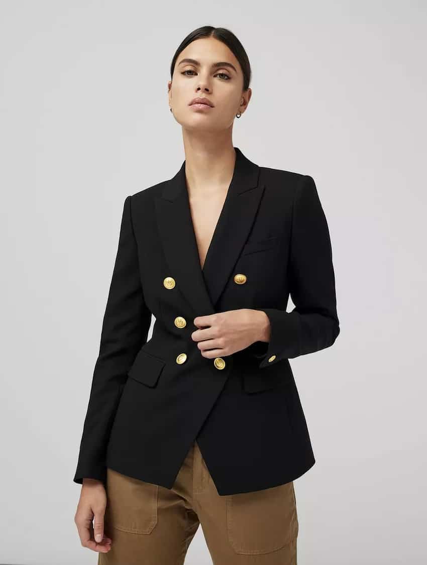 image of a woman wearing a black blazer with gold buttons, flap pockets, and brown cargo pants