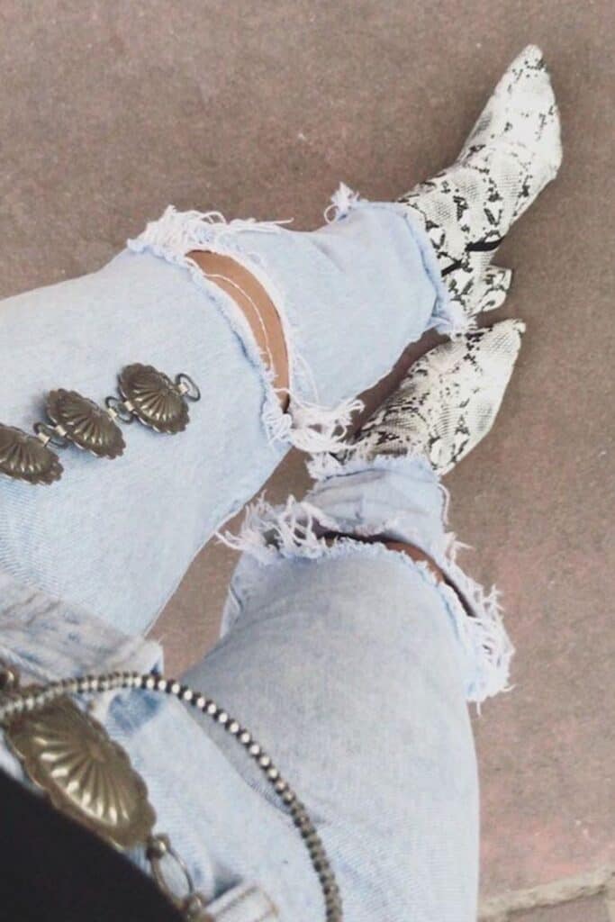 an image of a woman's legs in jeans and snakeskin cowboy boots
