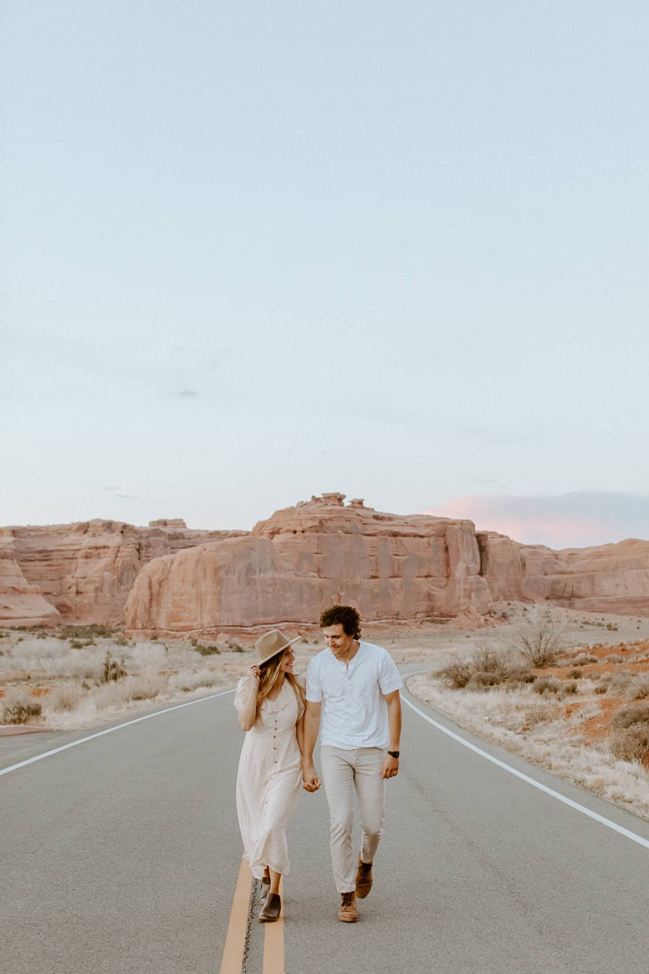 Young man and woman holding hands in the desert