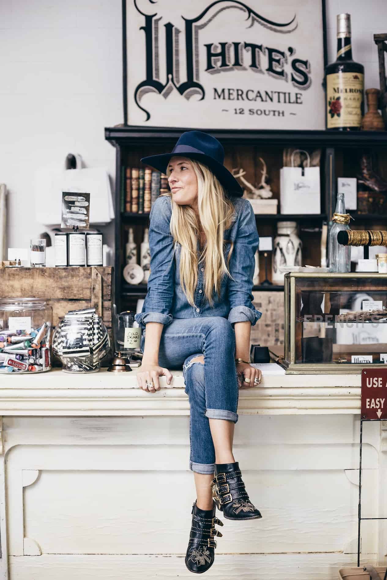 Woman sitting on the counter of White's Mercantile in the Nashville 12 South area.