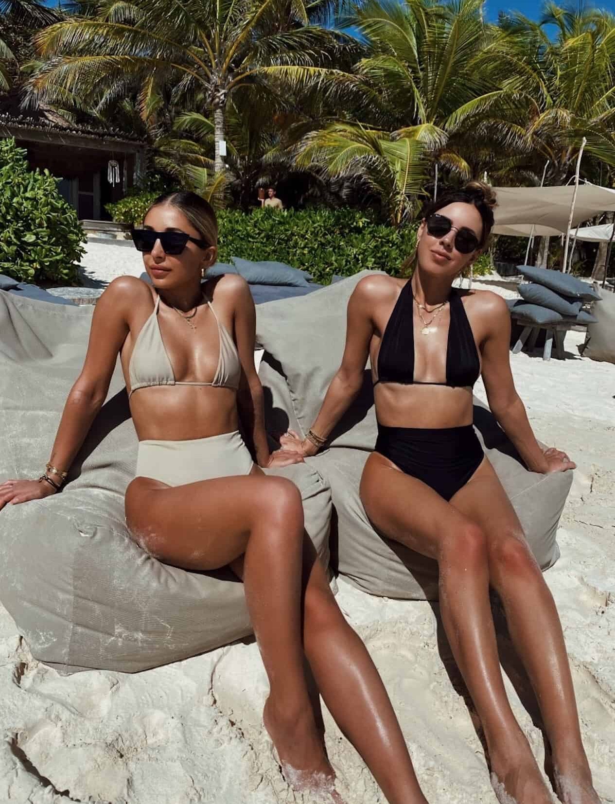 Two women in high-waisted bikinis on the beach in Mexico.