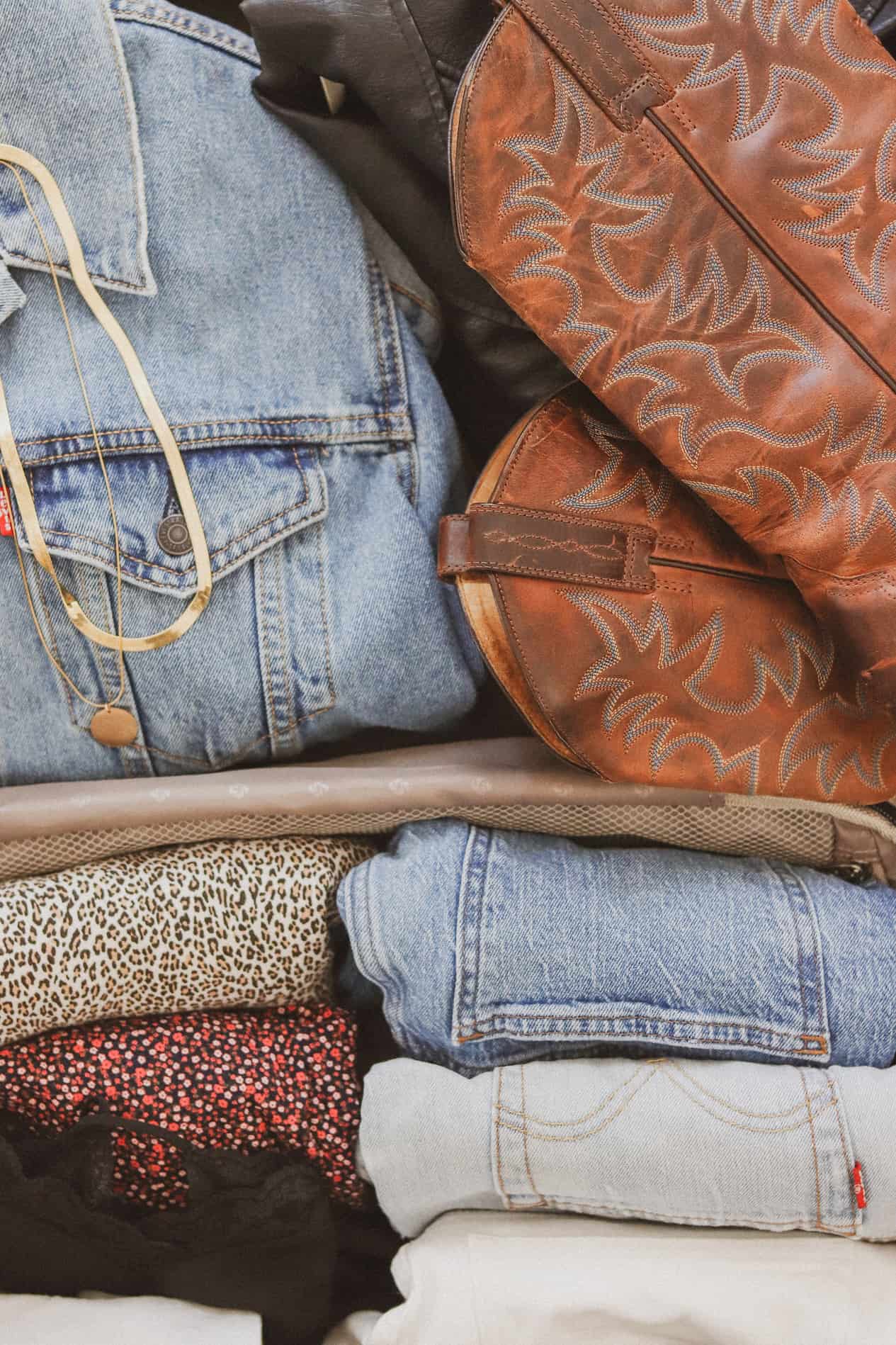 Close up image of a suitcase filled with clothes to wear on a trip to Nashville.
