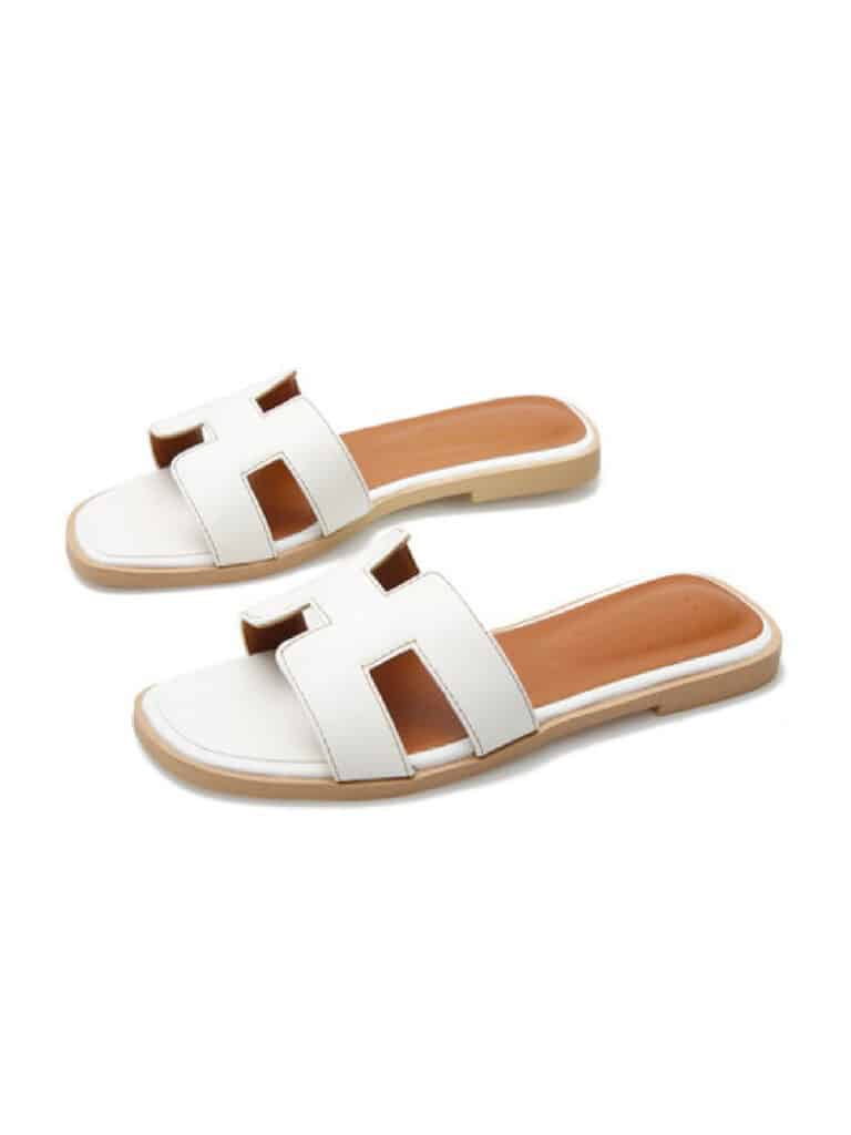 image of a pair of white sandals that look like Hermes Oran sandals