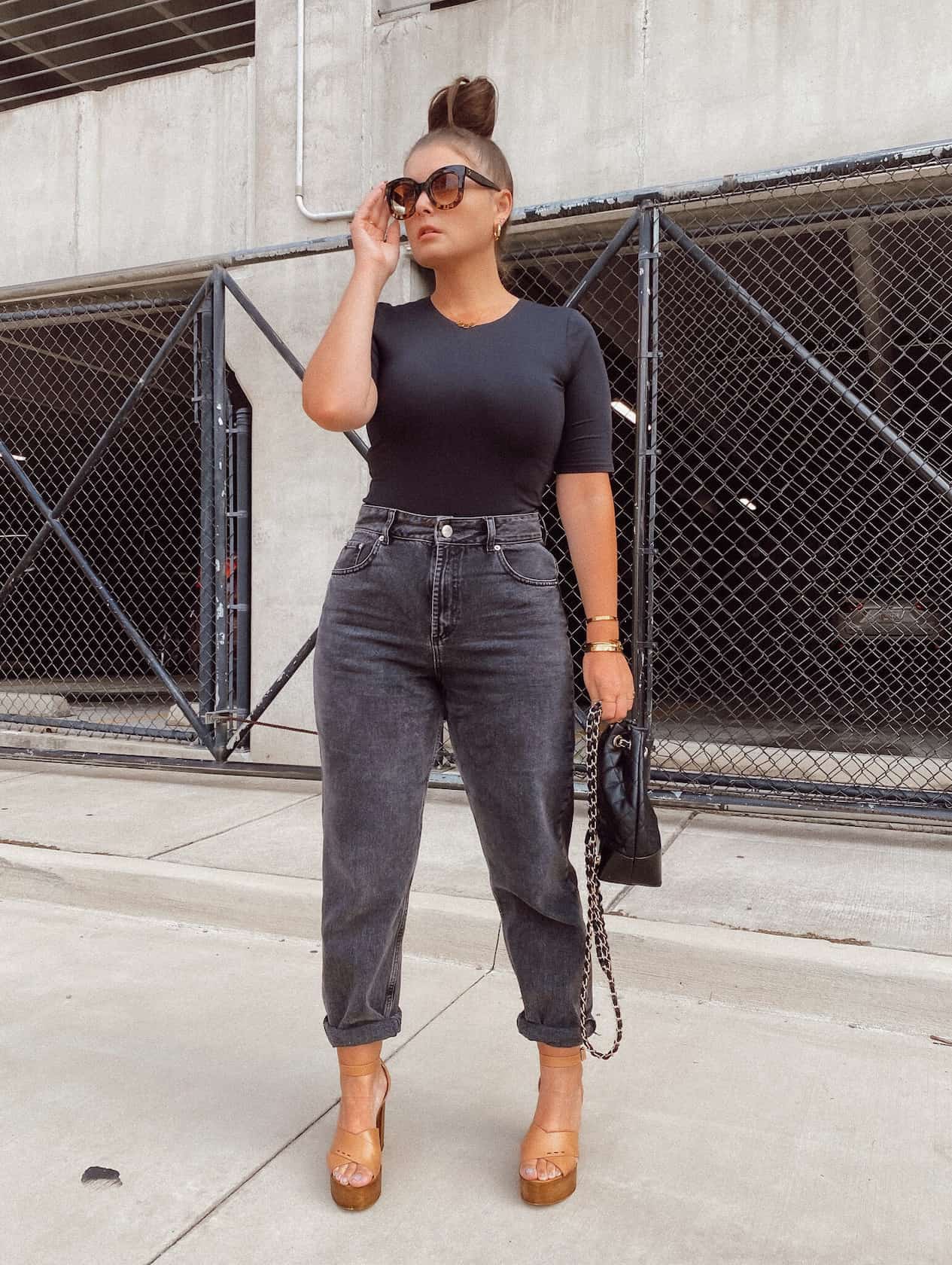 Woman wearing black jeans and a black fitted tee.