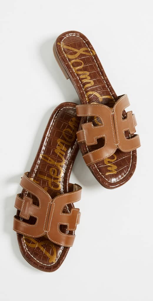 an image of two brown leather sandals with a cut out design on the top