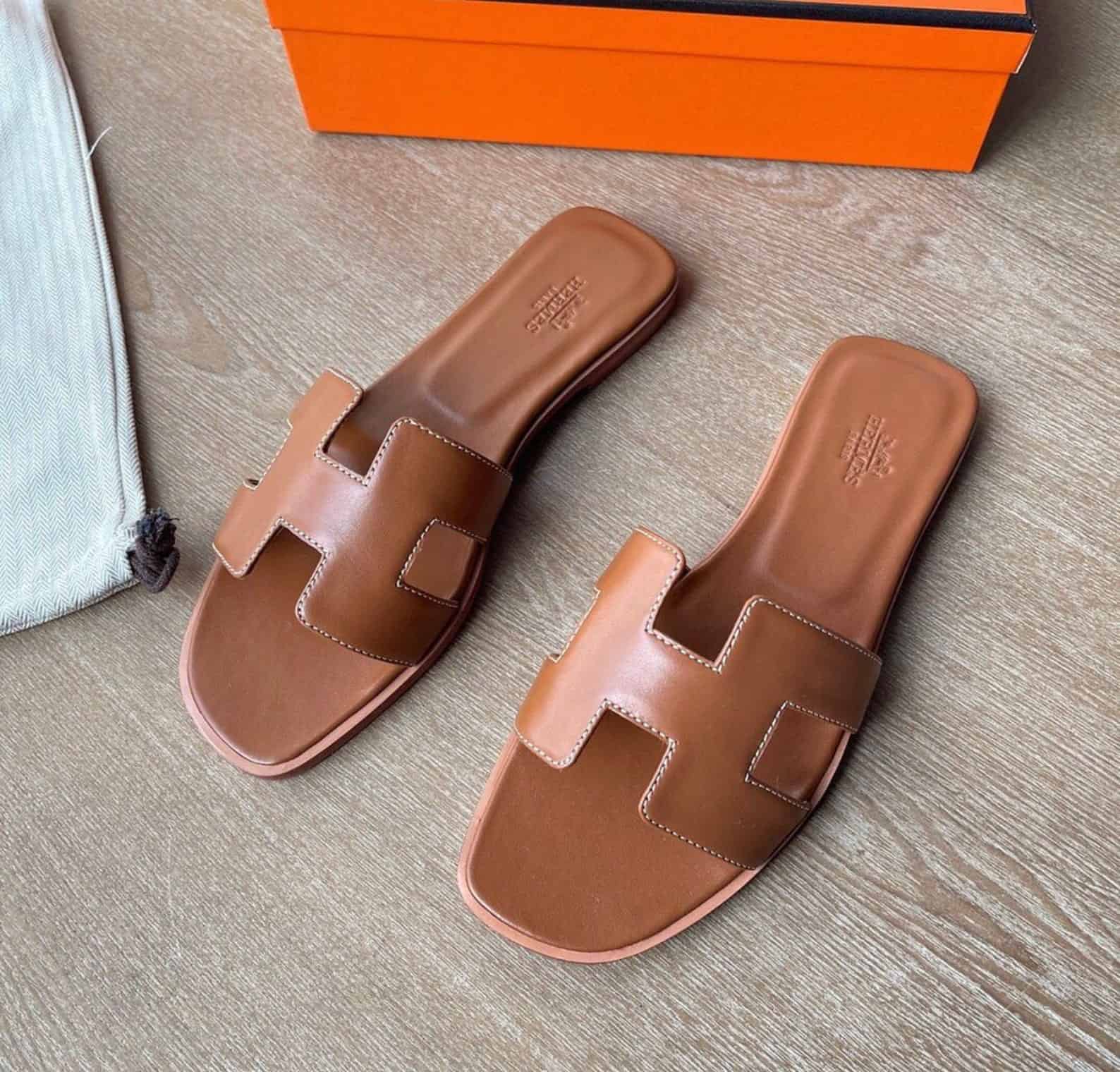 image of a brown leather sandal with an H cut-out shape on the top