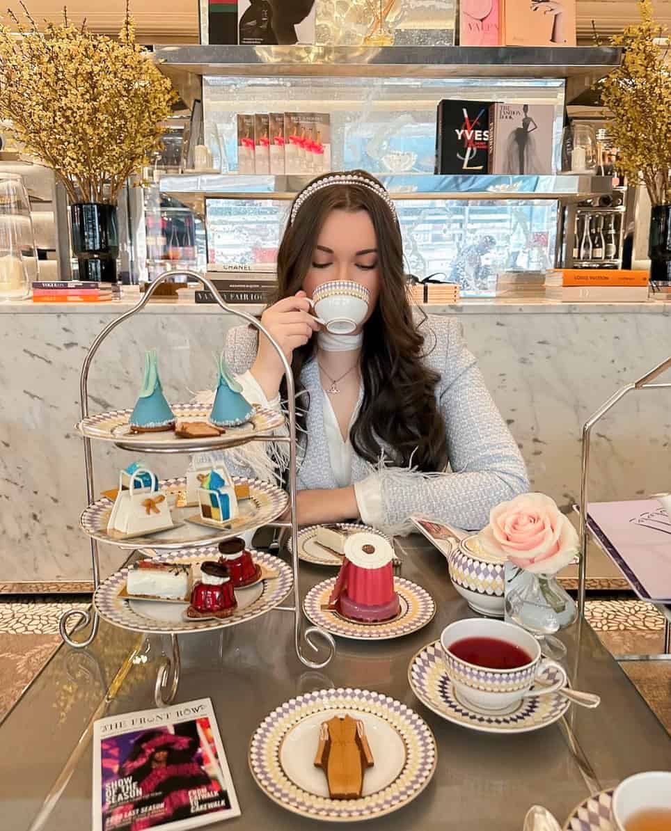 image of a woman at High tea wearing a blue tweed jacket and stylish headband