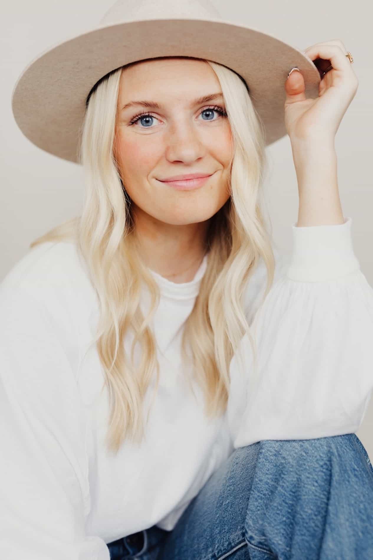 Headshot of a woman wearing a felt hat.