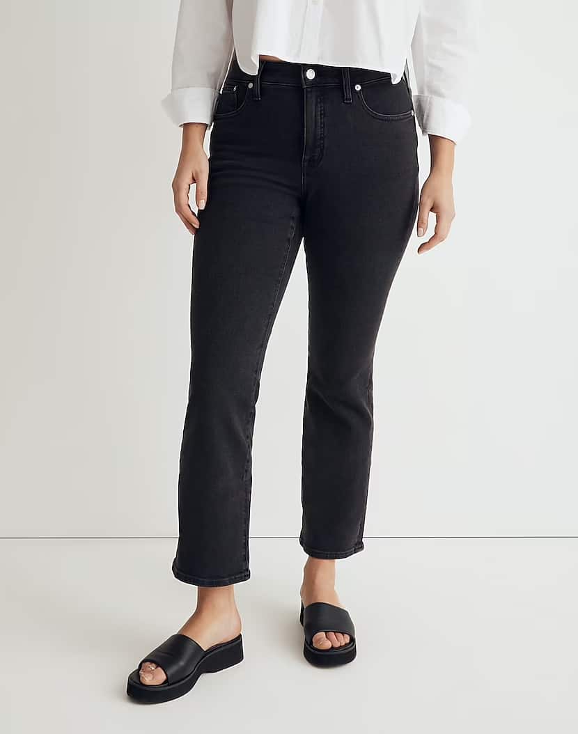 mid-size woman from the waist down wearing black kick crop jeans with black sandals