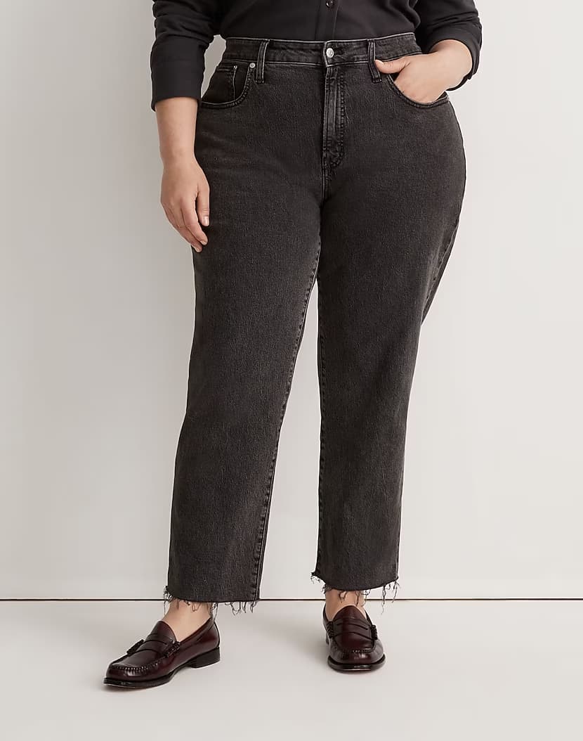 image of a plus-size woman from the waist down wearing faded black straight leg jeans with black loafers
