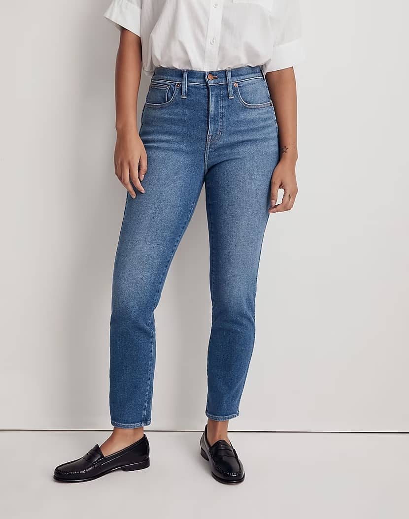 mid-size woman wearing curvy straight leg blue jeans with black loafers