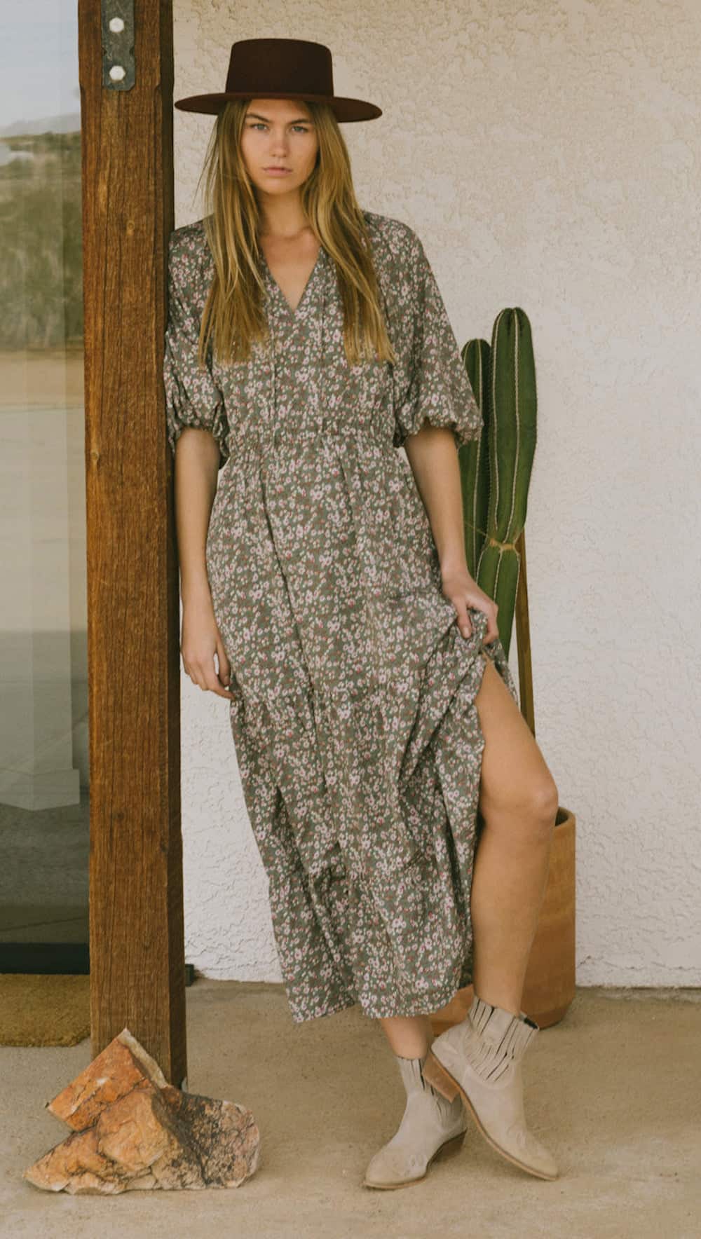 image of a woman in a long maxi floral dress, rancher hat, and western style booties