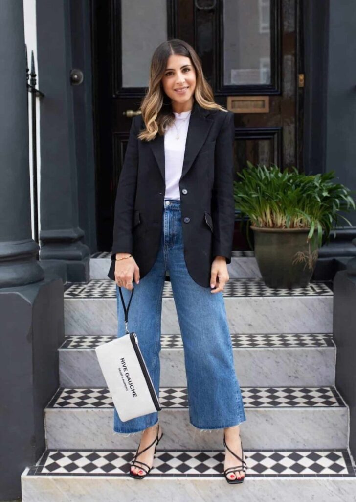 Image of a woman wearing wide leg jeans and a blazer.
