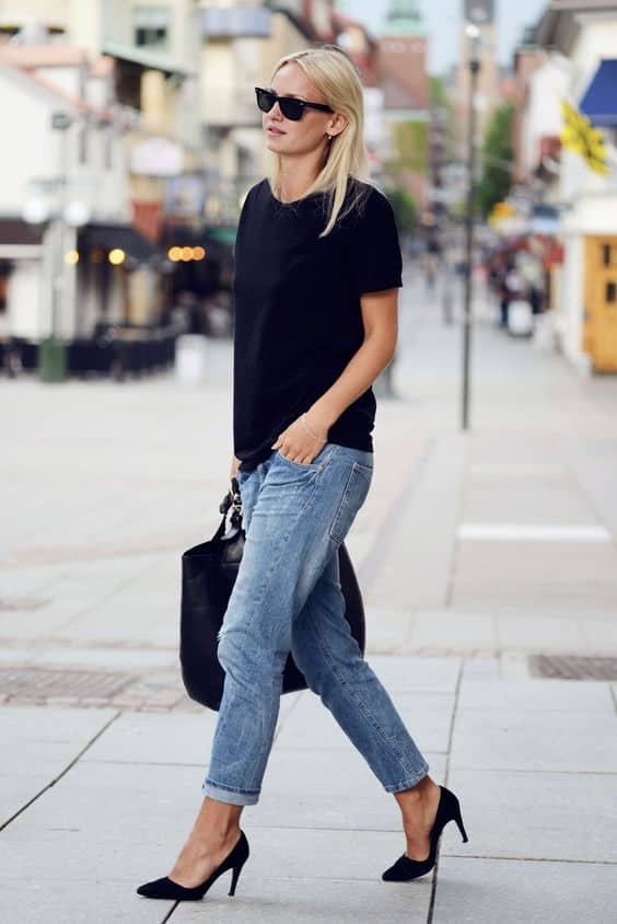 image of a woman wearing boyfriend jeans, a black t-shirt, and pumps