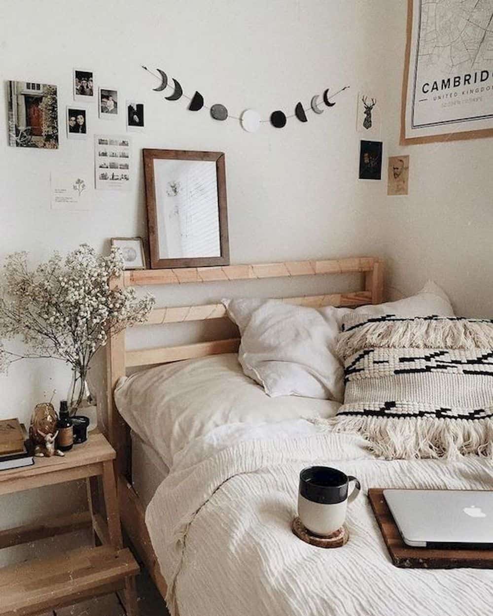 image of a wooden bed with neutral sheets and minimal art on the walls