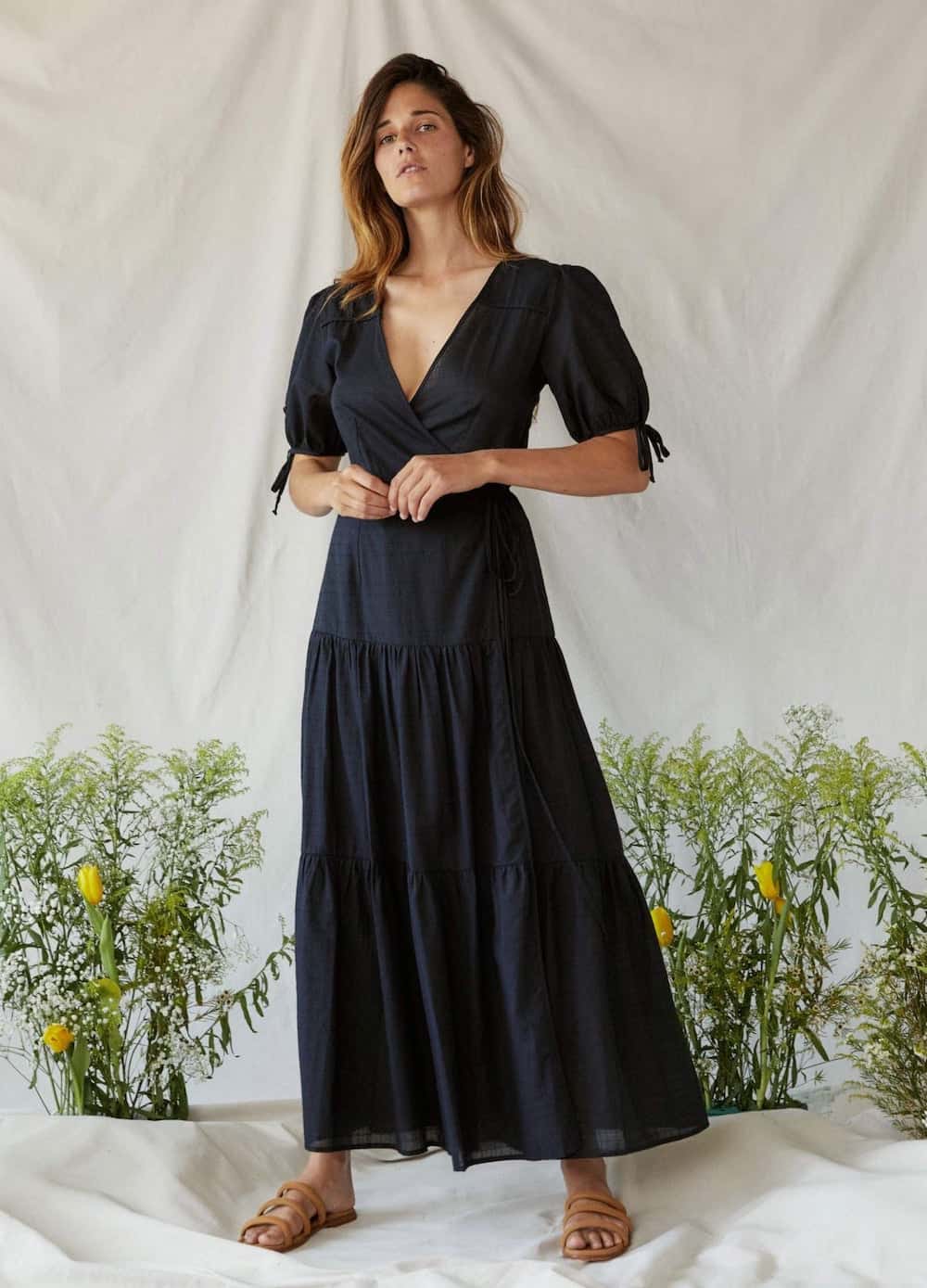 image of a woman in a black maxi dress with puff sleeves