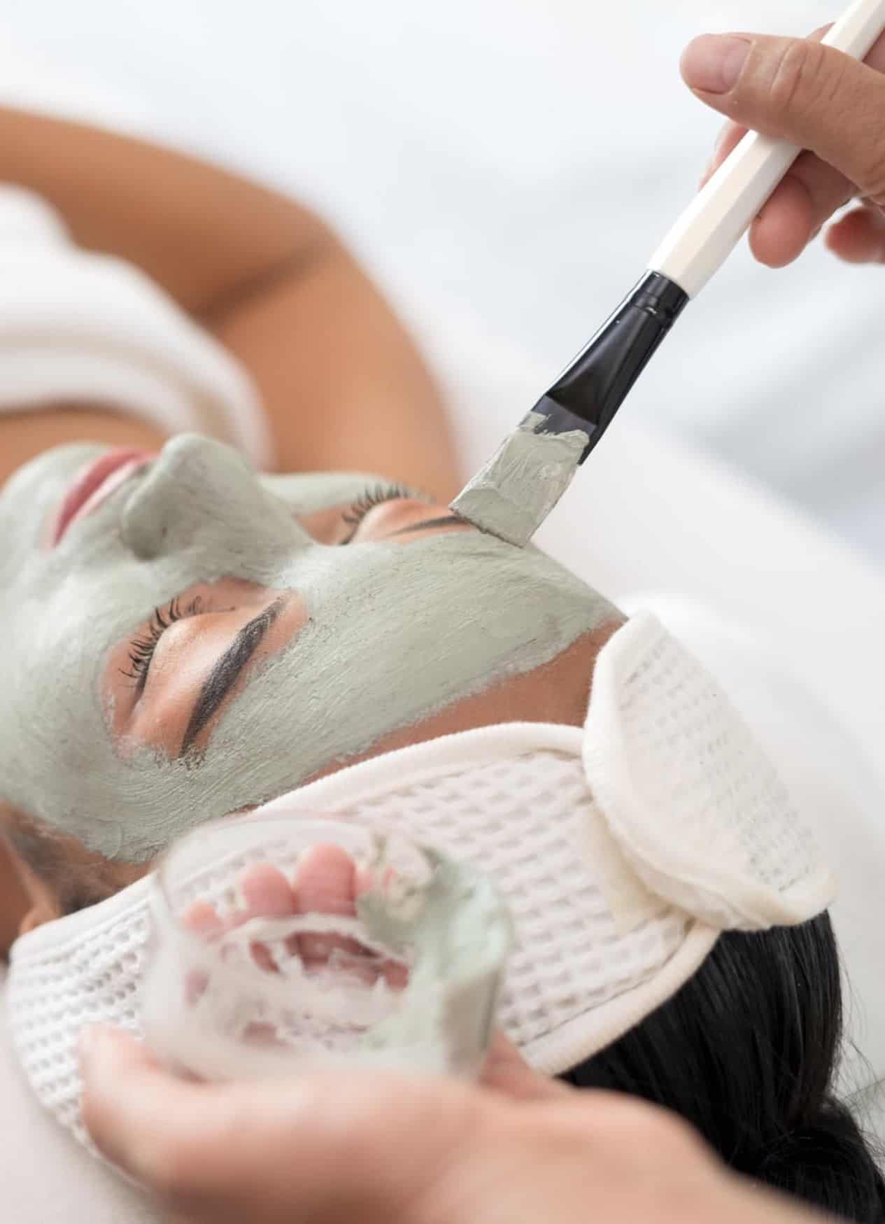 image of a woman getting a facial with green lotion