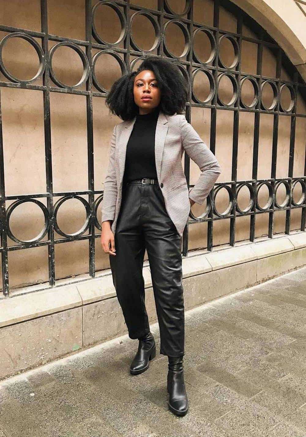 image of a stylish black woman in a plaid blazer with black leather trousers and black boots