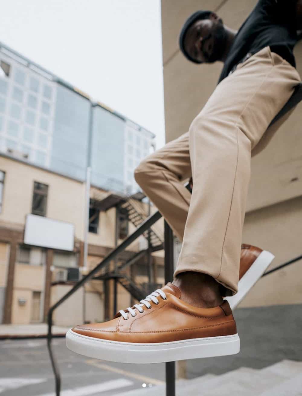 image of a mans legs wearing khaki pants and brown leather sneakers
