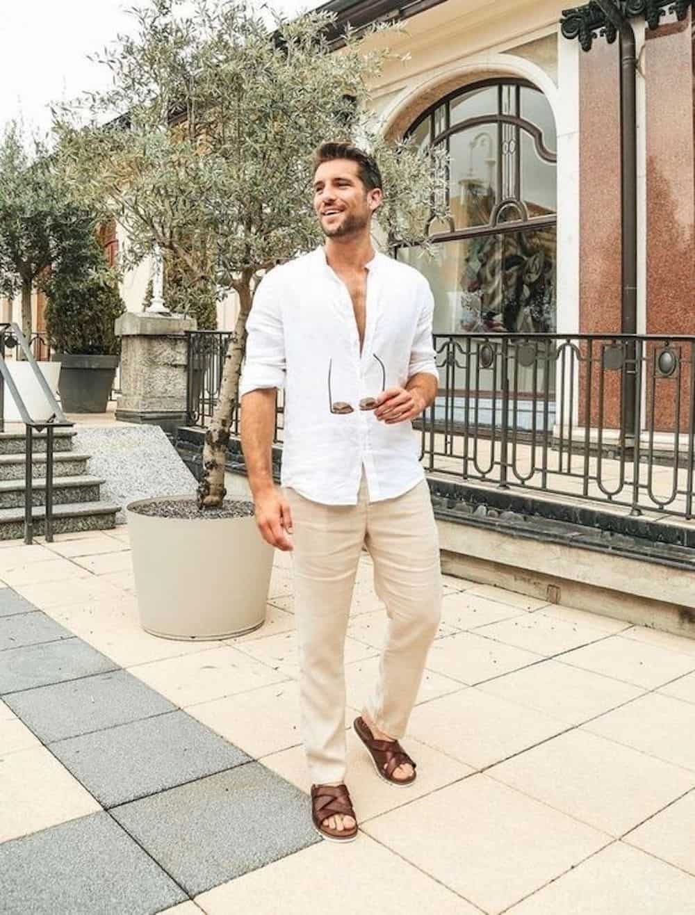 image of a man wearing a white button up shirt, light khaki chinos, and brown sandals