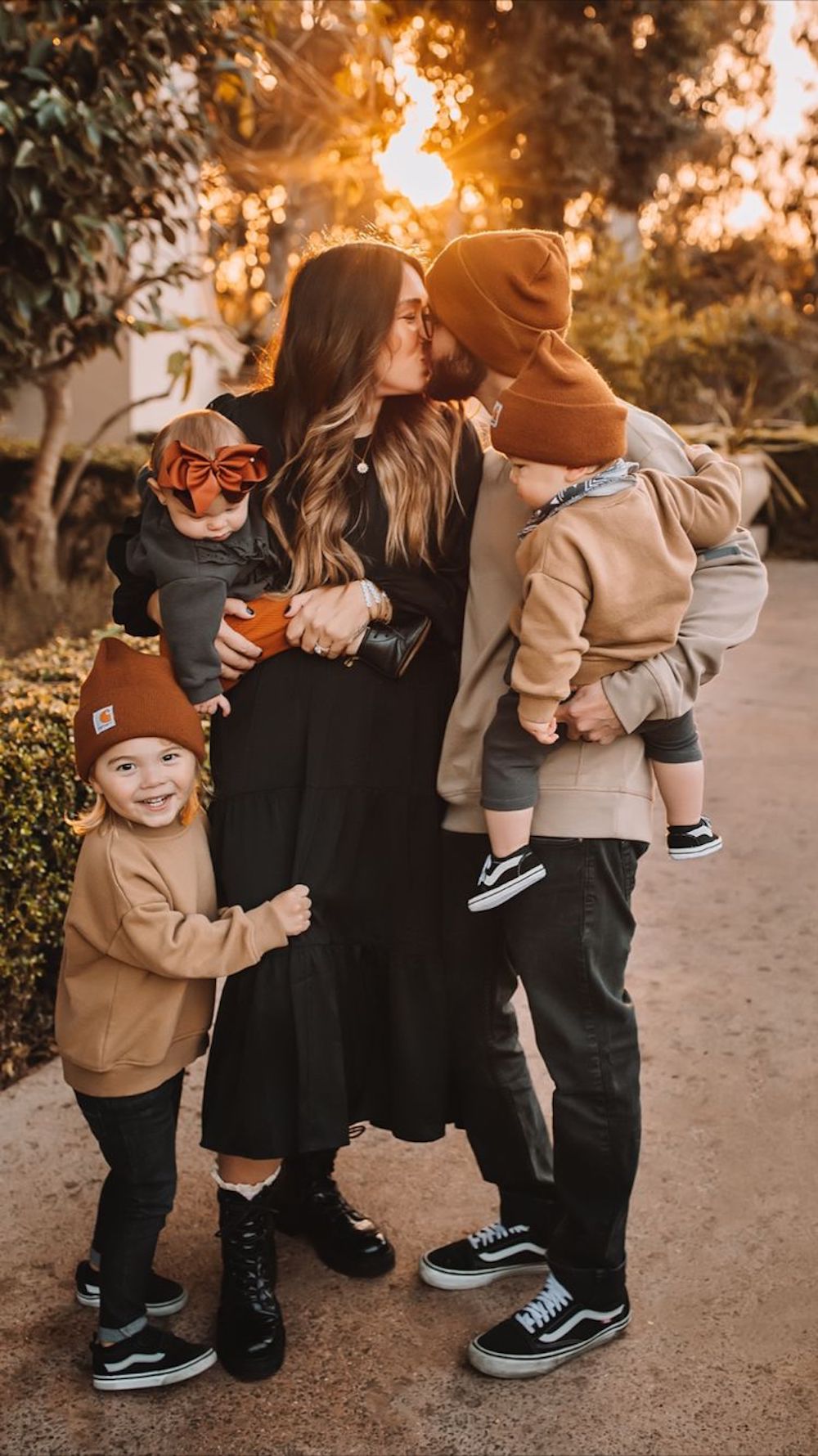 image of a family in casual sweatshirts and beanies for a fall family photoshoot