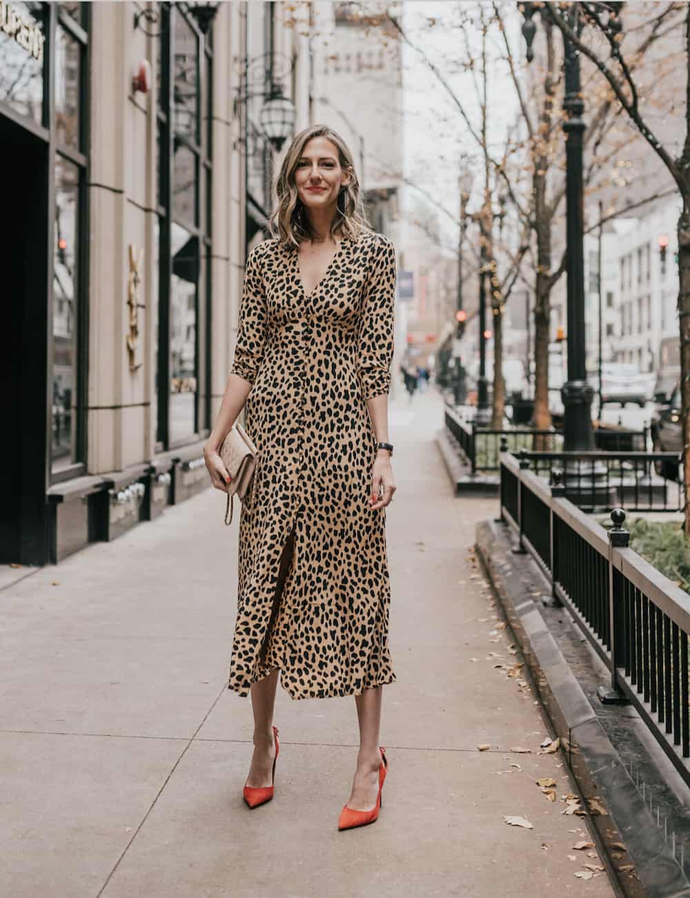 image of a woman in a long sleeve leopard print midi dress and red heels