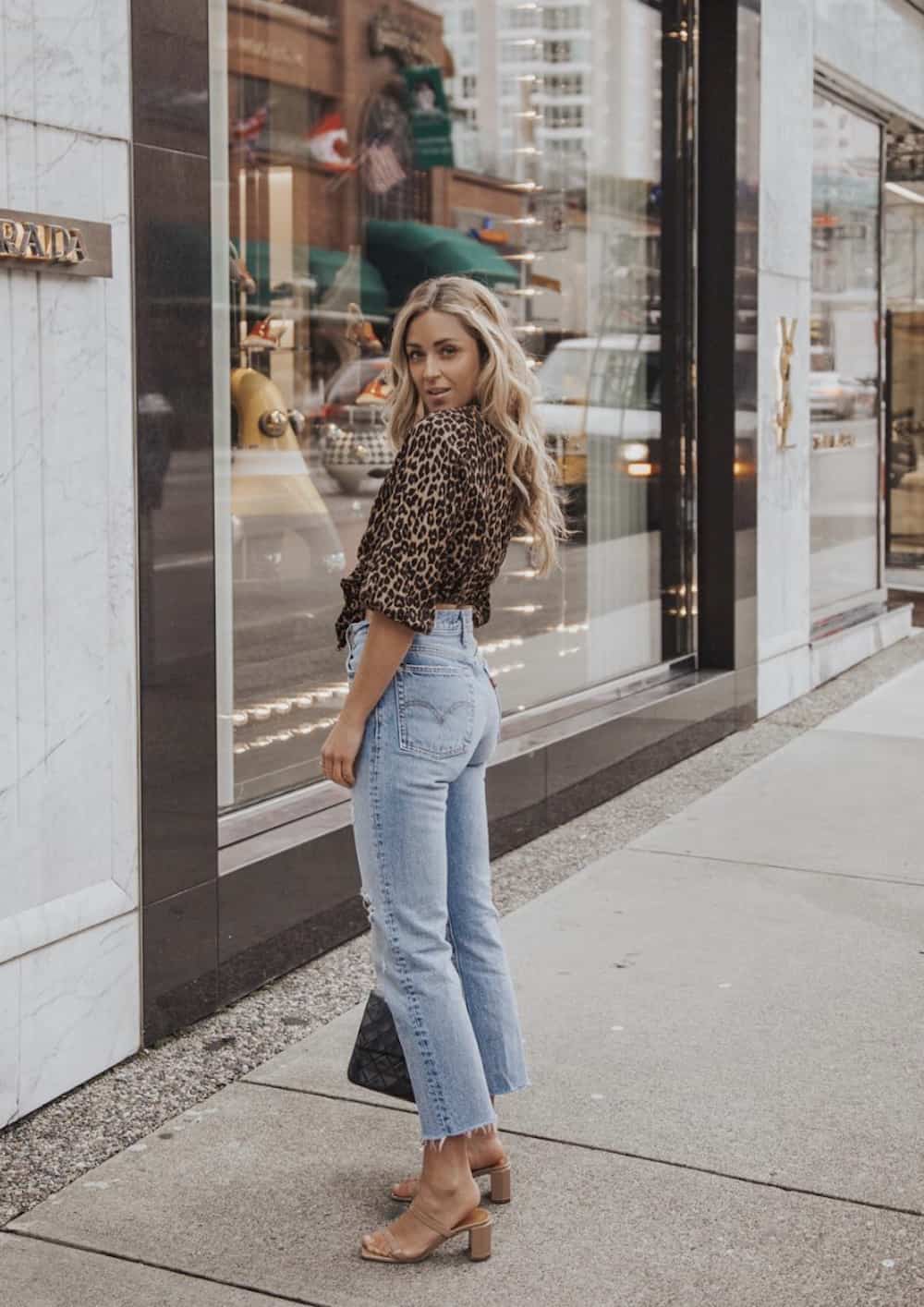 image of a woman in a leopard blouse and vintage Levi jeans with heels