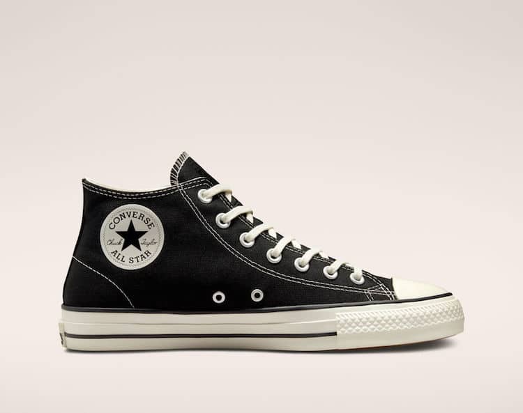 image of a pair of black converse high top sneakers with a star on the side and white sole