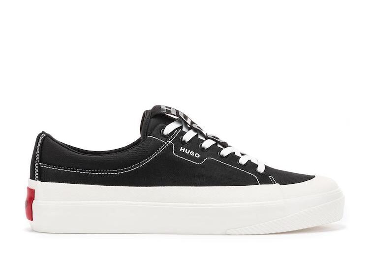 image of a pair of black canvas lace-up low top sneakers with a thick white sole