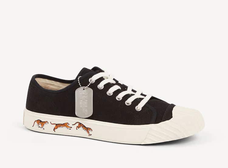 image of a pair of black lace up canvas sneakers with a white sole with tiger graphics on the sole