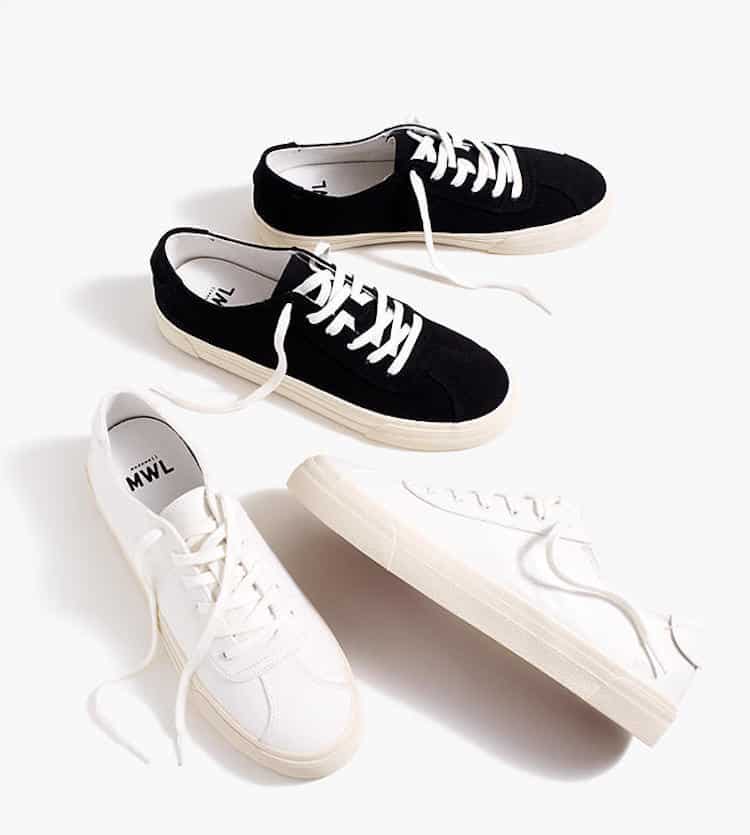 image of two pairs of canvas sneakers one in black and one in white