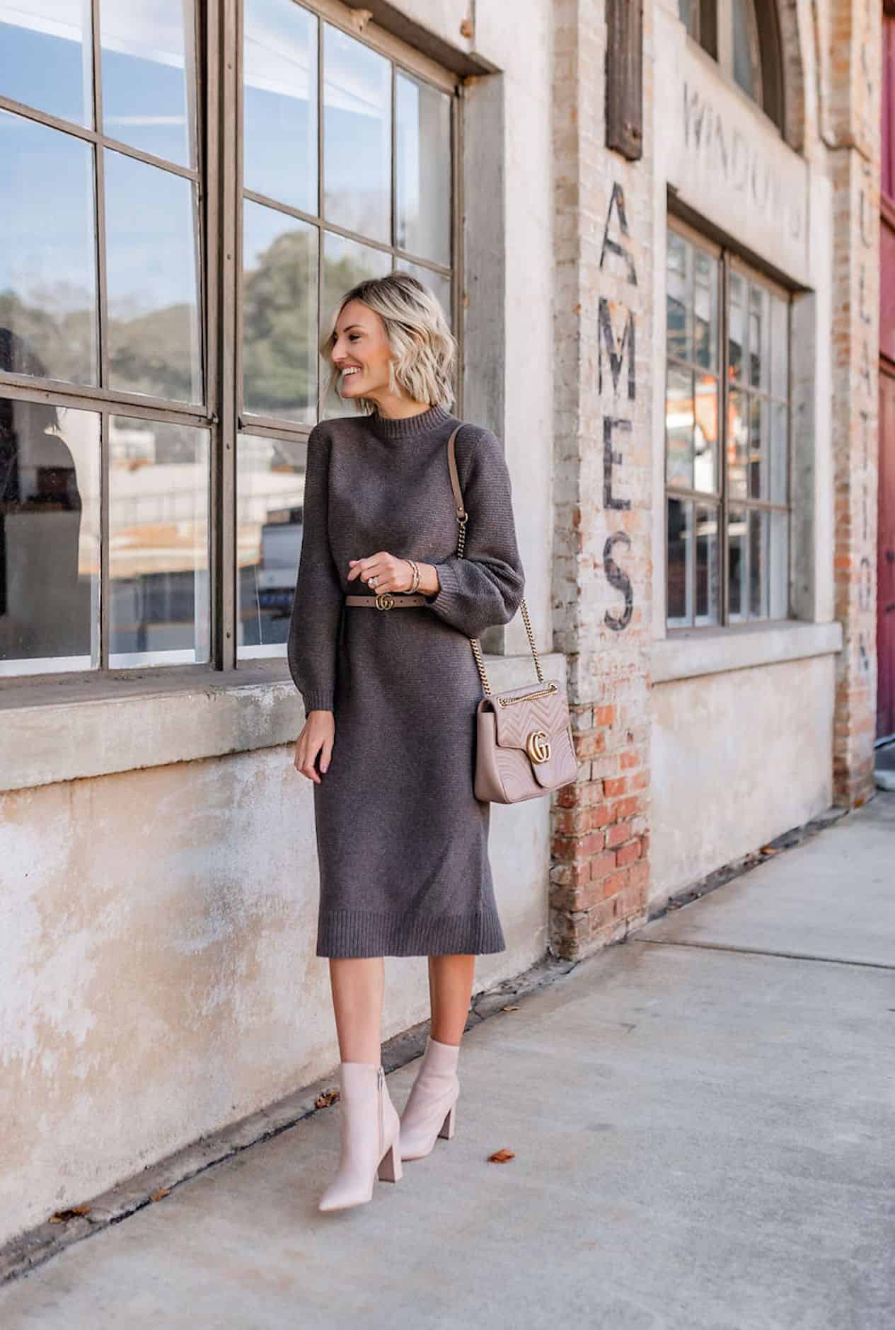 Woman wearing a sweater dress and heeled booties