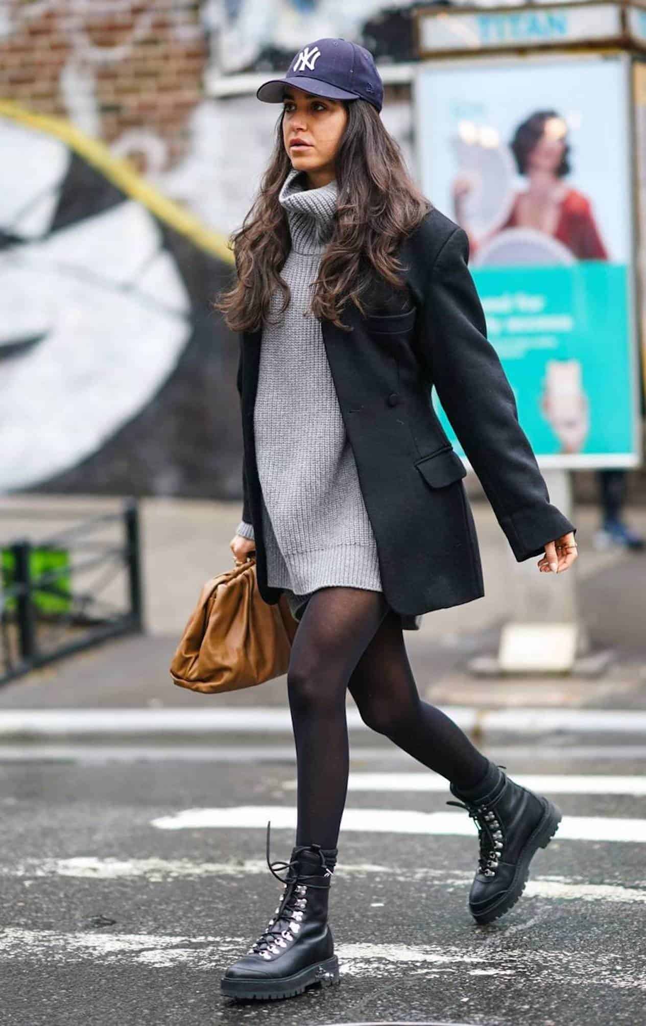 Woman wearing a sweater dress and combat boots.