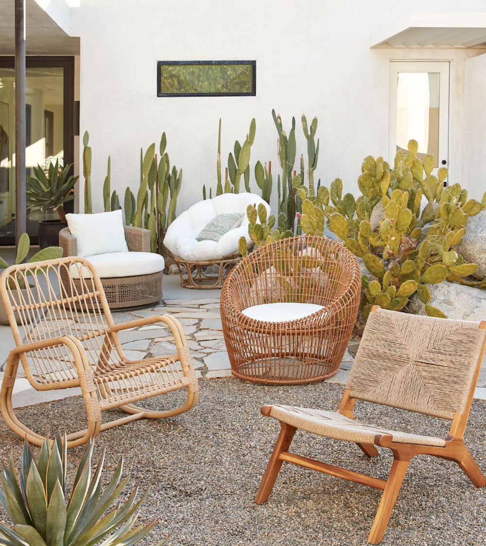 image of a backyard with cactus plants and boho style rattan chairs