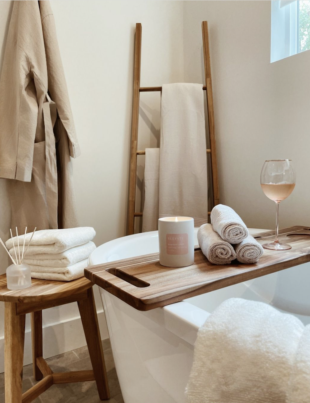 image of a bathroom tub with a spa caddy and white towels