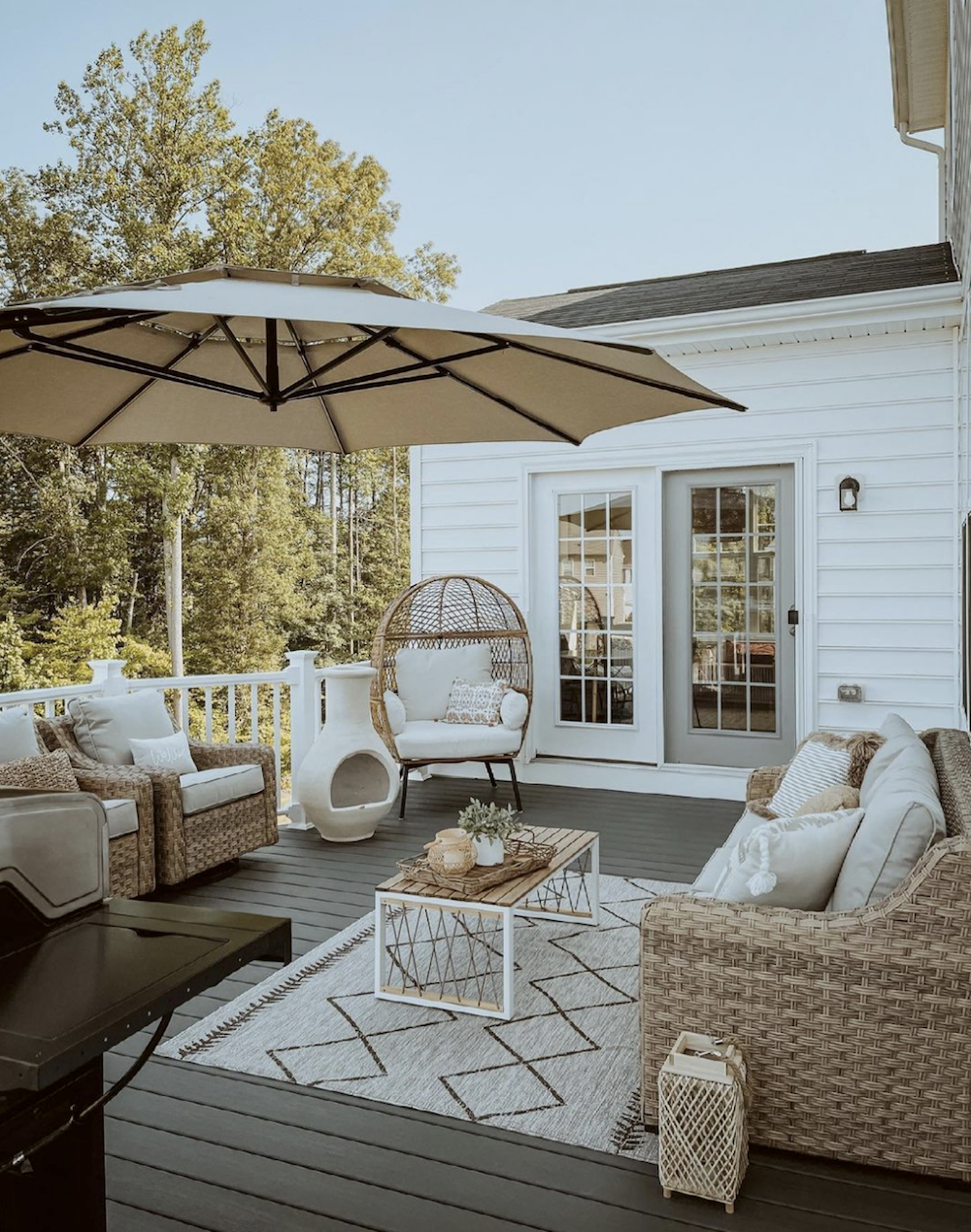 image of a patio with neutral rattan furniture and white accents