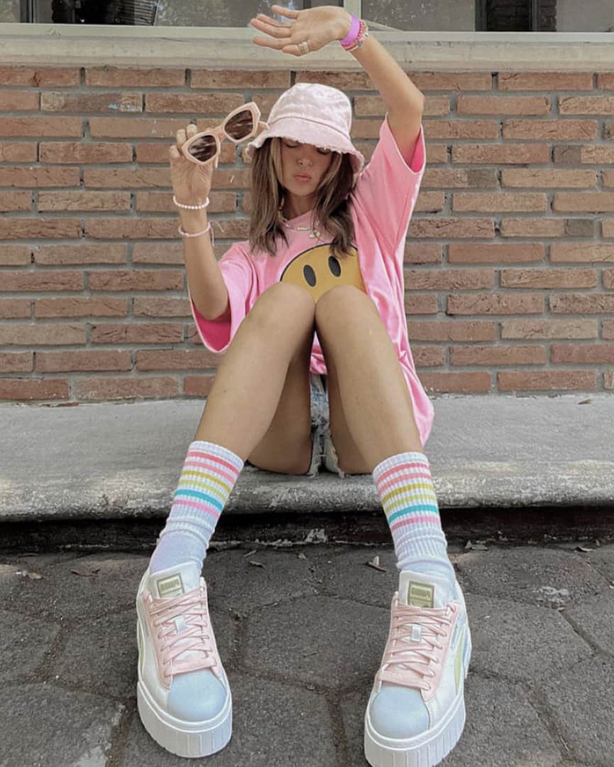 image of a girl in skater style clothing sitting on a curb 