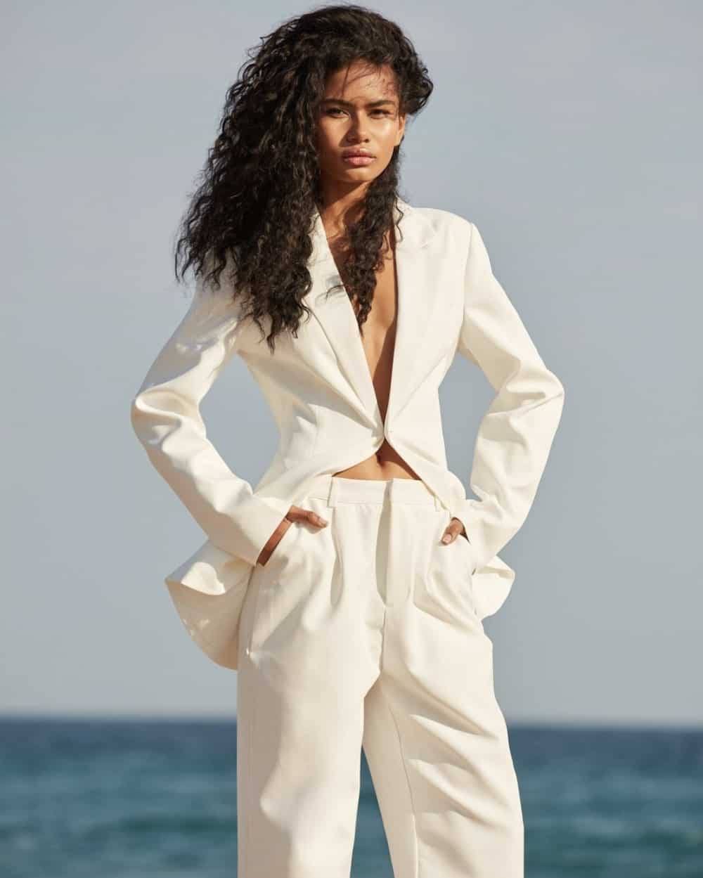 Woman wearing an all white suit.