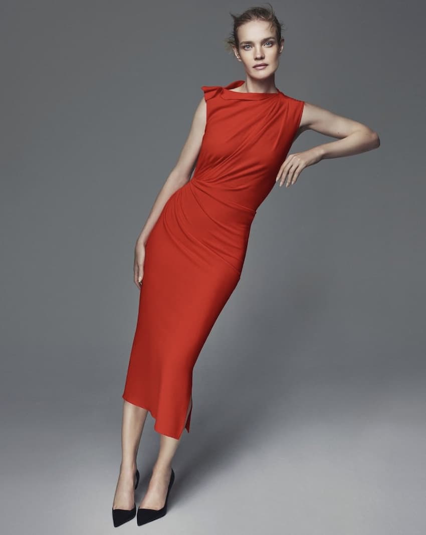 Woman wearing a red midi dress.