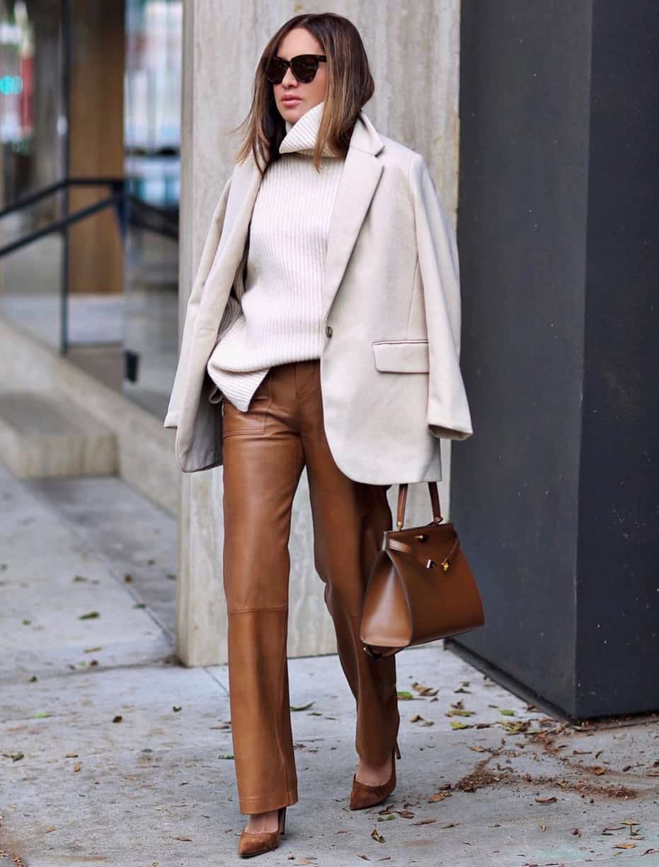 image of a woman in an oversized ivory turtleneck, wool cream blazer, brown leather pants, and brown suede pumps
