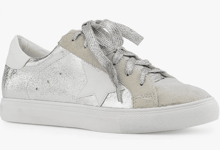 image of a shiny silver sneaker with a white star detail on the side and grey laces
