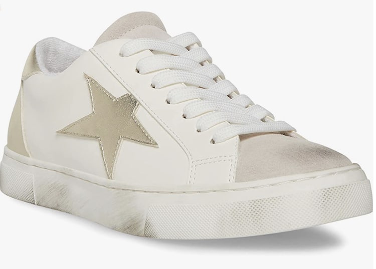 image of a white distressed sneaker with purposeful scuffs and a gold star detail on the side