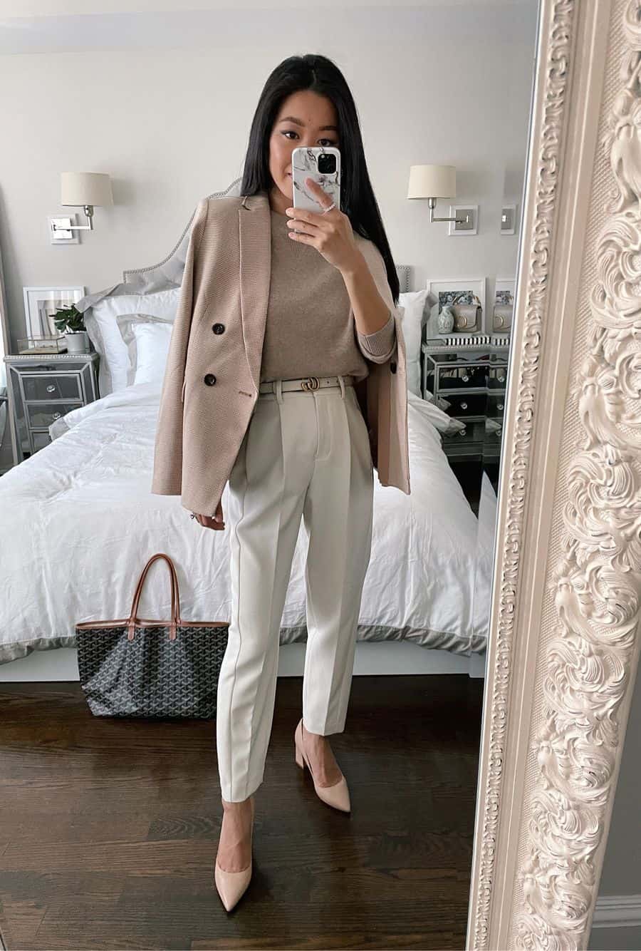image of a woman wearing ivory trousers, nude pumps, a nude Gucci belt, and a beige sweater with a wool blazer