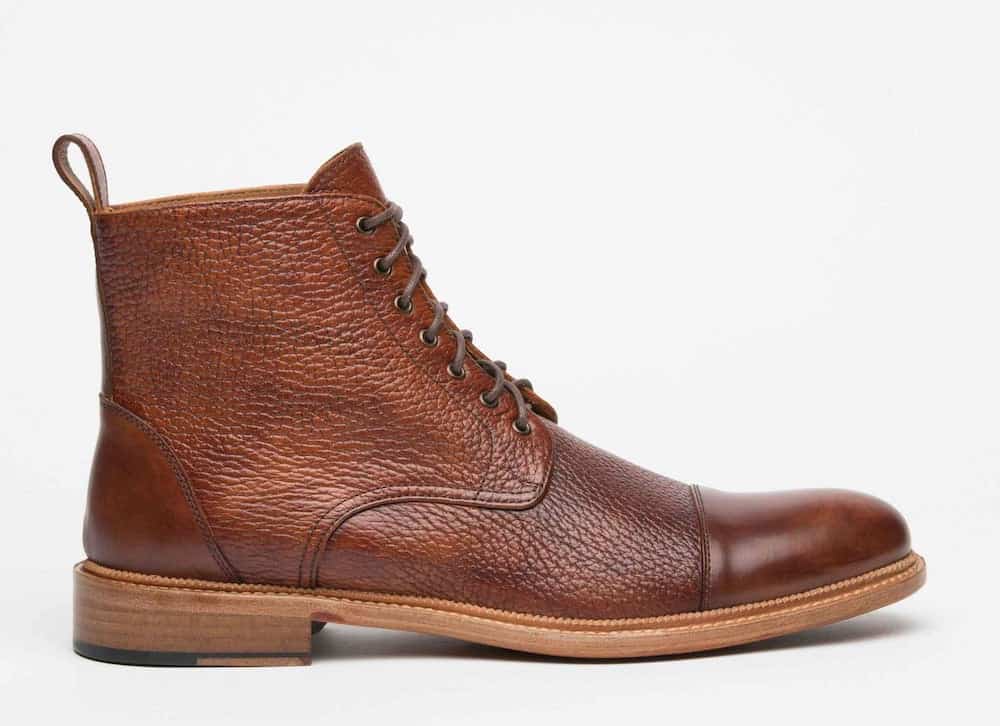 image of a brown leather mens wingtip boot in a brushed cognac color