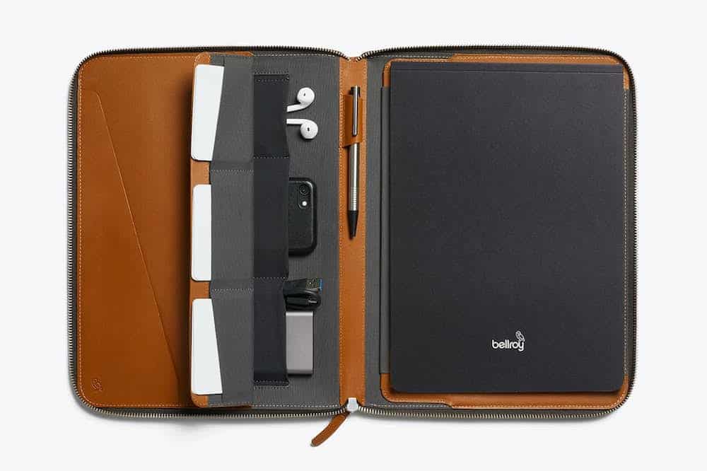 image of a brown leather work portfolio case with a notebook and pens inside
