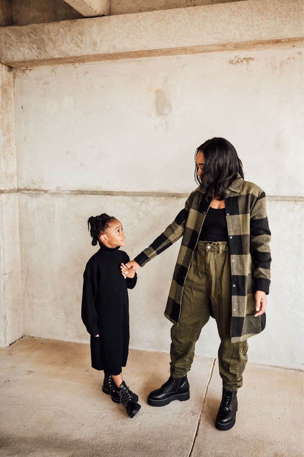 image of a black woman and her daughter wearing a green long check jacket, green cargo pants, and black boots