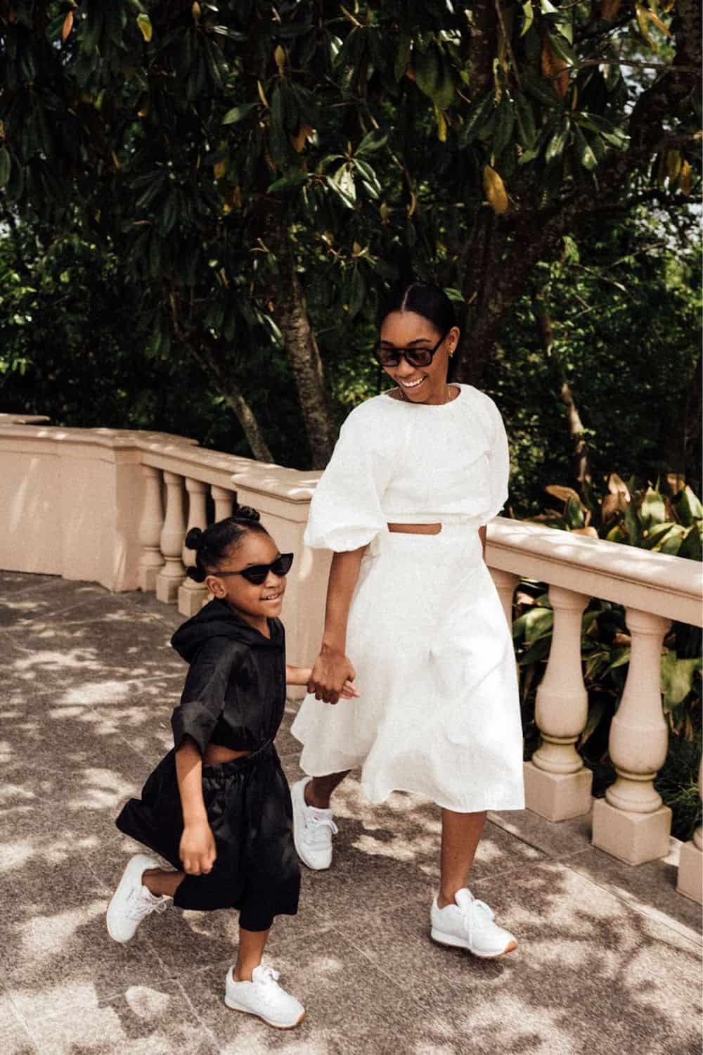 image of a black woman and her daughter both wearing midi dresses and white sneakers