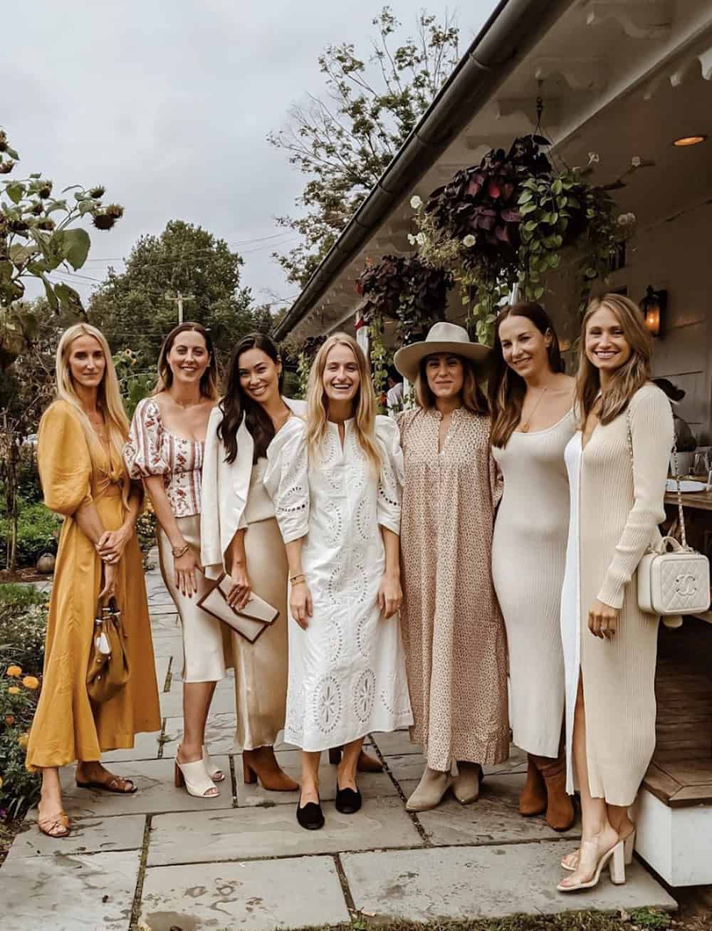 image of a group of seven women all wearing stylish long dresses