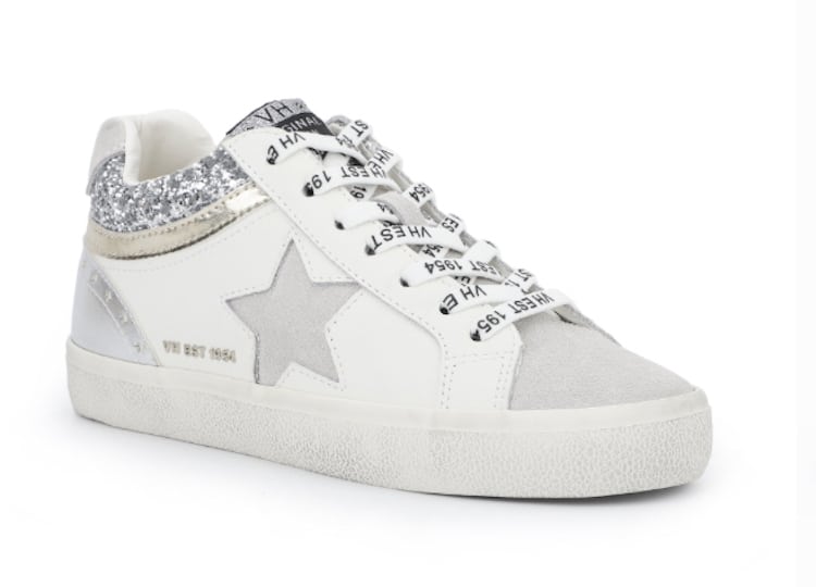 image of a pair of white mid-top sneakers with a star detail on the side and printed laces