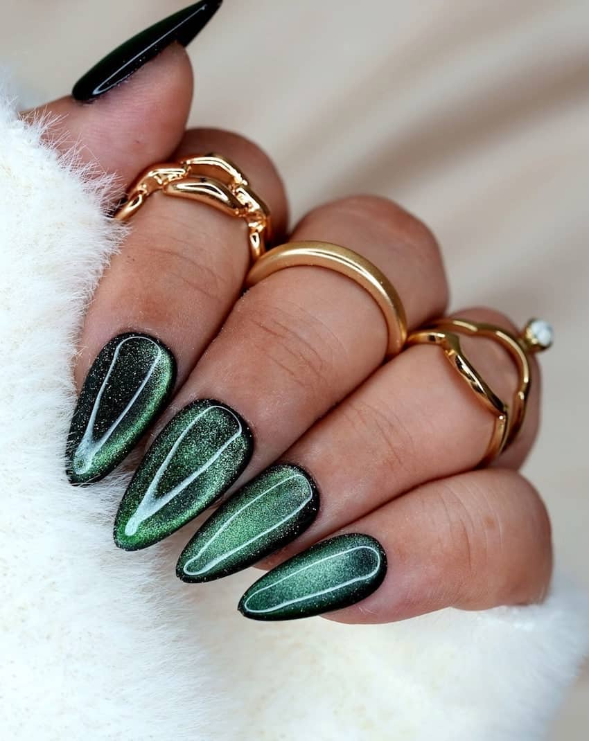Long emerald green sparkly nails.